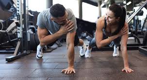 Sculpting Sleek Arms: The Essential Role of Cardio in Toning Without Bulking Up 1 Image of man and woman doing Cardio West Bridgford to tone their arms.